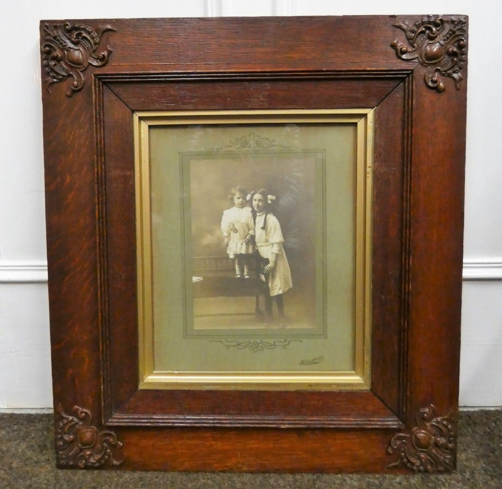 Pair of antique framed sepia family portraits housed within carved dark oak frames featuring inner gold gilt borders. View IV