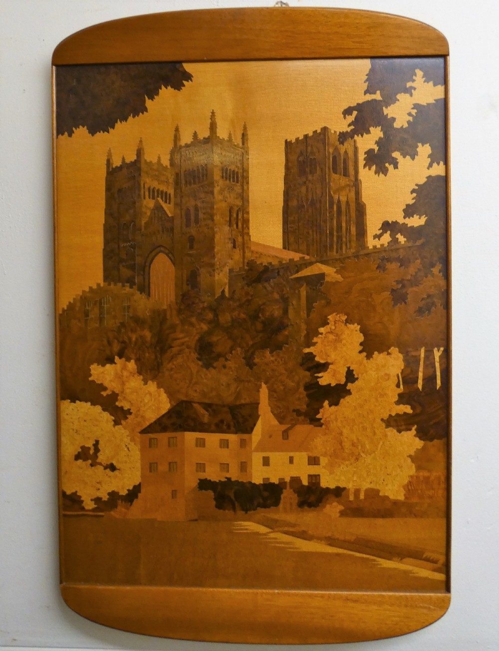 A rectangular wood marquetry wall panel depicting Durham Cathedral rendered in contrasting shades of natural wood veneer.