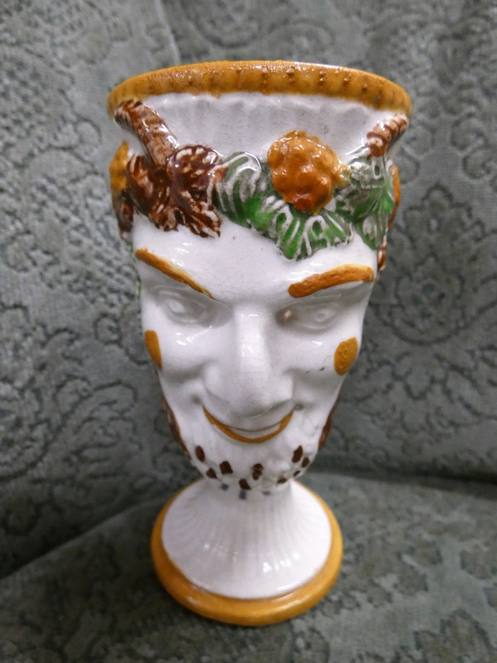 A Georgian Staffordshire earthenware mug moulded in the shape of the mythological figure Bacchus with polychrome glazes and a loop handle. View II