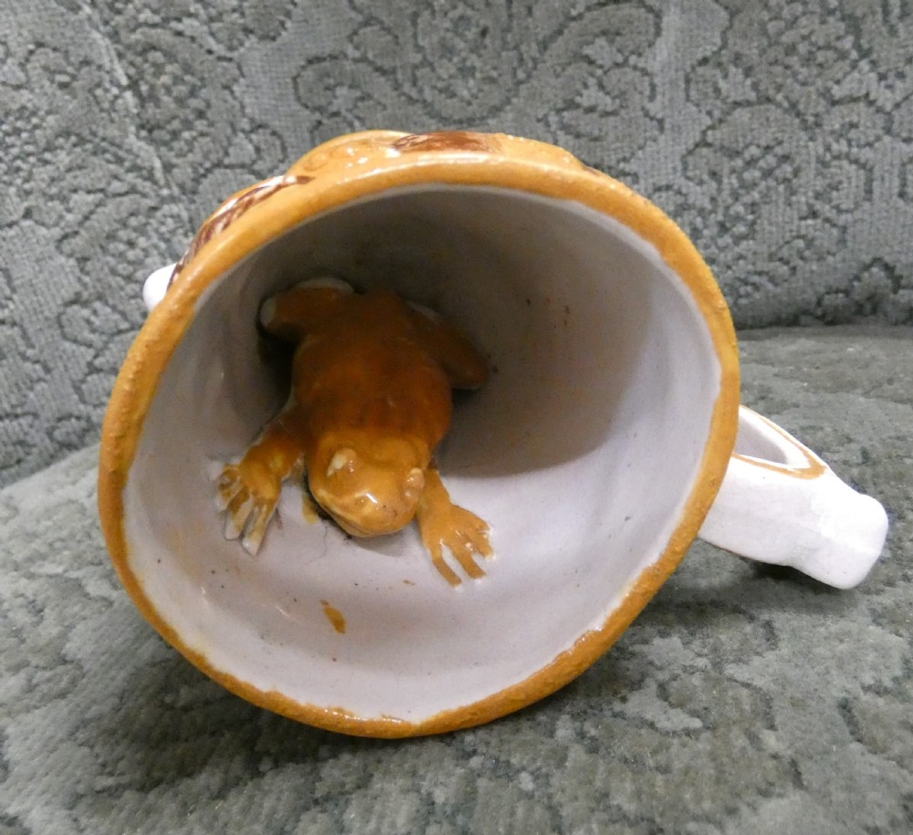 A Georgian Staffordshire earthenware mug moulded in the shape of the mythological figure Bacchus with polychrome glazes and a loop handle. View III