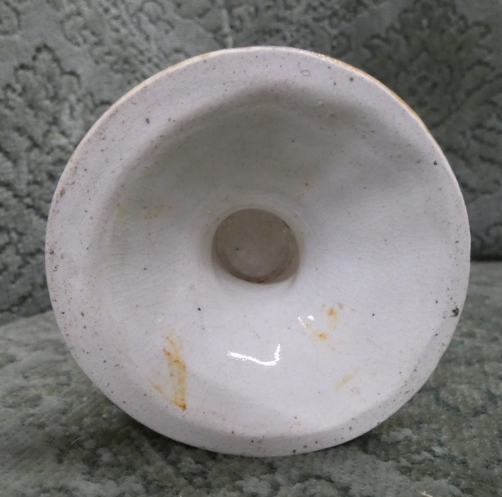 A Georgian Staffordshire earthenware mug moulded in the shape of the mythological figure Bacchus with polychrome glazes and a loop handle. View V