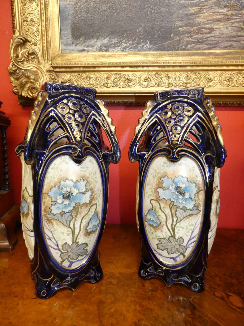A pair of Art Nouveau ceramic vases with reticulated cobalt blue and gilt borders around hand-painted blue floral panels. View II