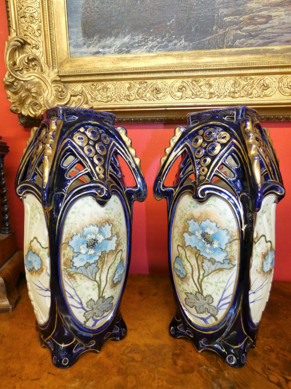 A pair of Art Nouveau ceramic vases with reticulated cobalt blue and gilt borders around hand-painted blue floral panels. View VII