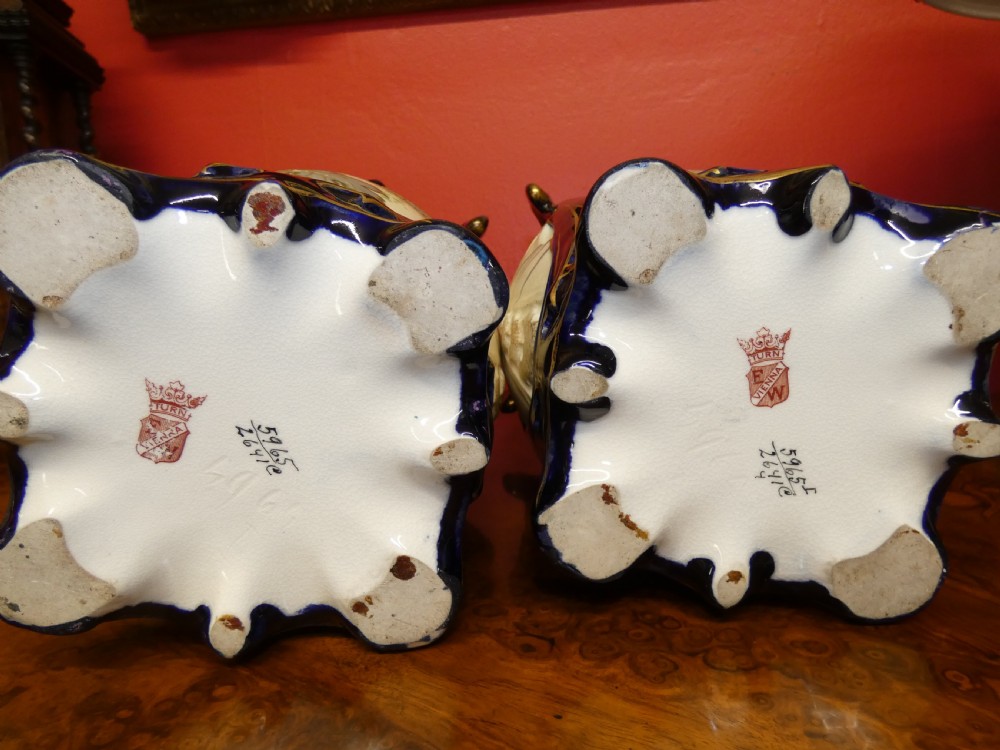 A pair of Art Nouveau ceramic vases with reticulated cobalt blue and gilt borders around hand-painted blue floral panels. View XI