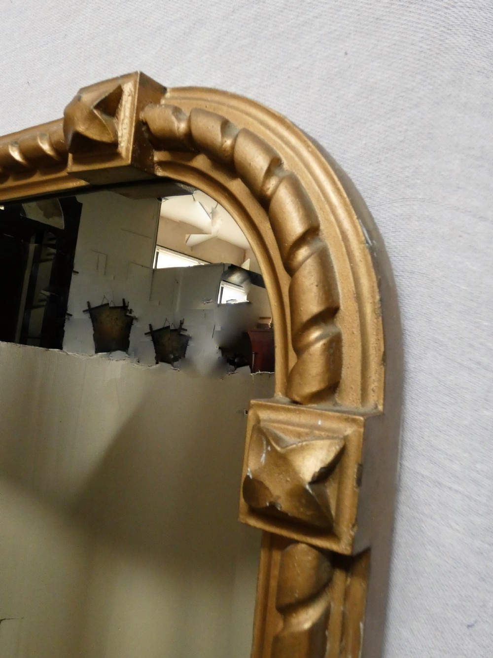 A large Victorian overmantel mirror featuring an arched gold giltwood frame with a rope-twist border and corner rosettes. View V