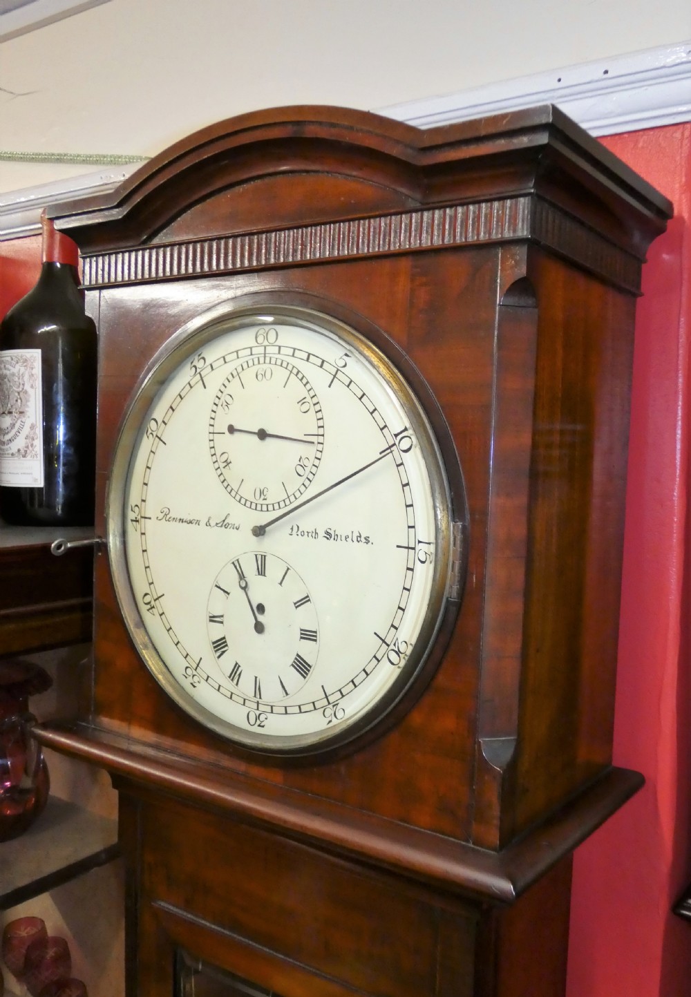 A Victorian mahogany longcase regulator clock featuring a circular dial with subsidiary dials and a glazed trunk displaying a mercury pendulum. View VI