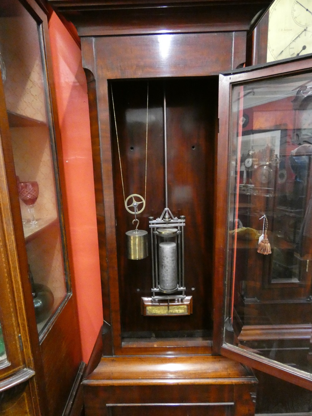 A Victorian mahogany longcase regulator clock featuring a circular dial with subsidiary dials and a glazed trunk displaying a mercury pendulum. View VIII