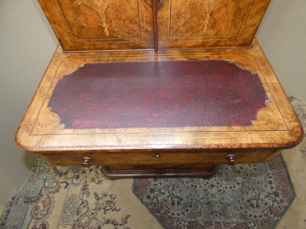 A Victorian burr walnut bonheur du jour writing desk with marquetry inlay, upper twin door cabinet, brass top gallery rail, and burgundy leather writing insert. View III