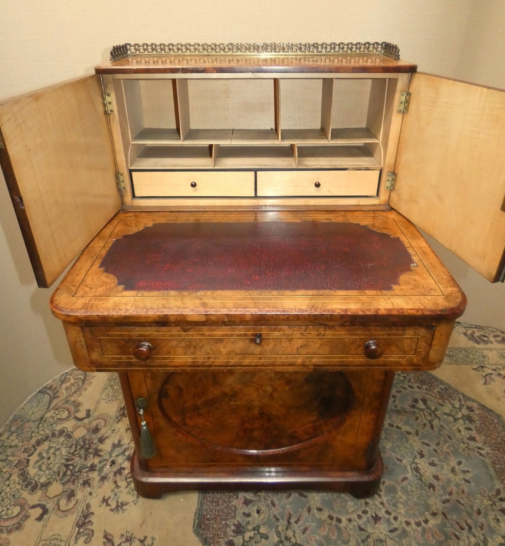 A Victorian burr walnut bonheur du jour writing desk with marquetry inlay, upper twin door cabinet, brass top gallery rail, and burgundy leather writing insert. View IV