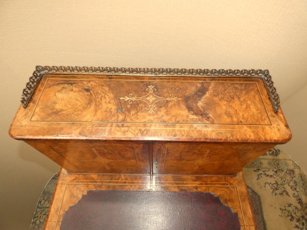 A Victorian burr walnut bonheur du jour writing desk with marquetry inlay, upper twin door cabinet, brass top gallery rail, and burgundy leather writing insert. View VII
