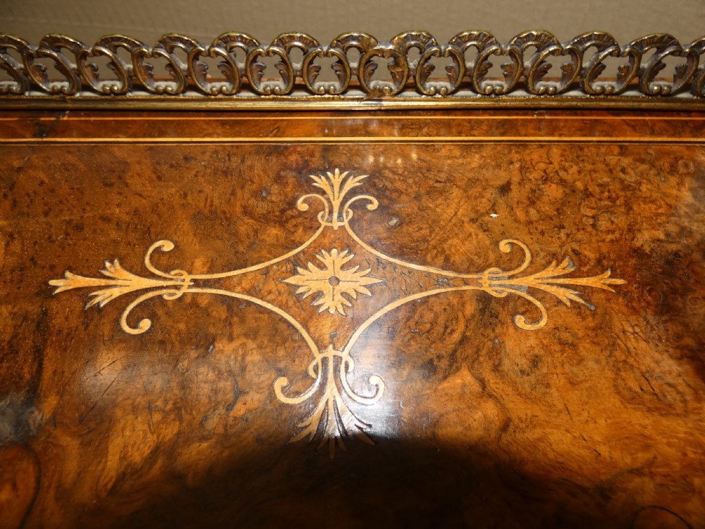 A Victorian burr walnut bonheur du jour writing desk with marquetry inlay, upper twin door cabinet, brass top gallery rail, and burgundy leather writing insert. View VIII