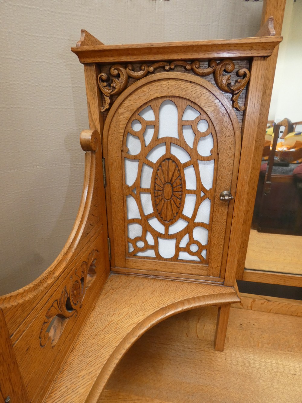 An Edwardian oak bedroom suite featuring a large three-door wardrobe with a central mirrored panel alongside a matching carved dressing table. View XII