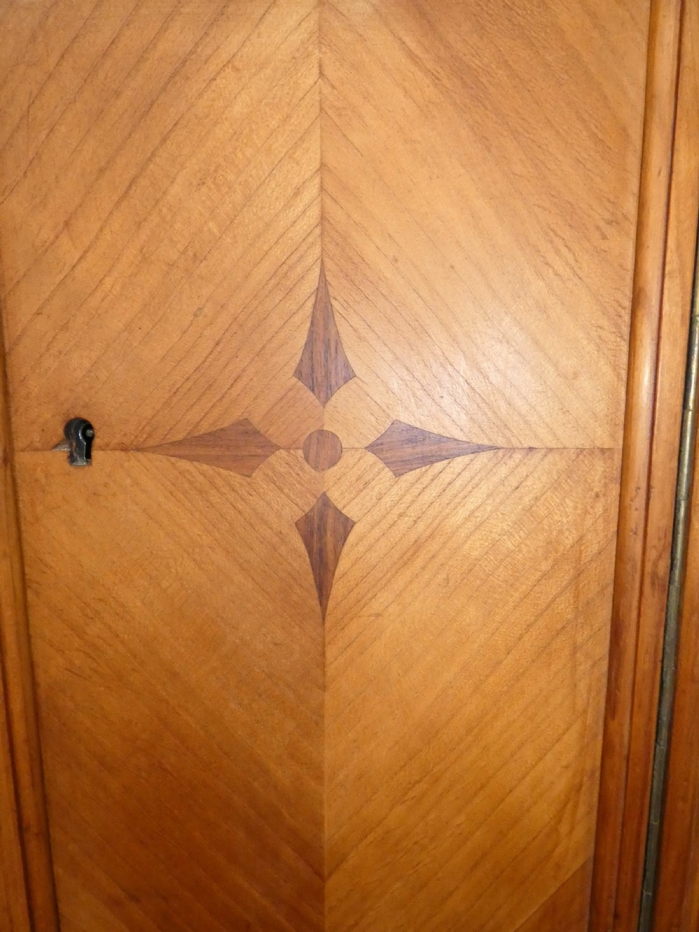 A satinwood dressing table featuring a central tall mirror flanked by two adjustable wing mirrors, twin pedestal cupboards with geometric star motif parquetry, and a central drawer. View VII
