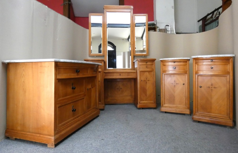 A satinwood dressing table featuring a central tall mirror flanked by two adjustable wing mirrors, twin pedestal cupboards with geometric star motif parquetry, and a central drawer. View IX