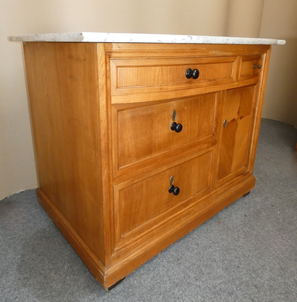A 19th-century timber washstand featuring a white marble top, three drawers with turned knobs, and a side cupboard door with geometric parquetry inlay. View II