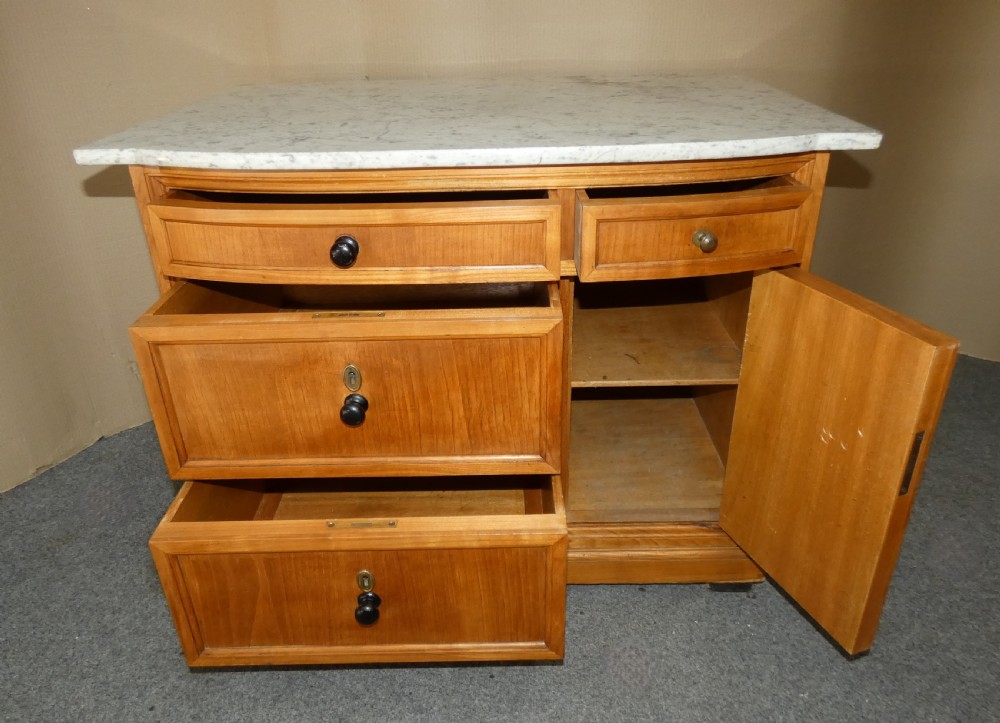 A 19th-century timber washstand featuring a white marble top, three drawers with turned knobs, and a side cupboard door with geometric parquetry inlay. View V