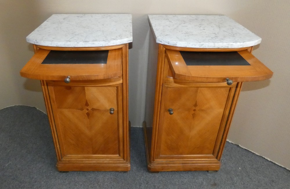 A pair of satinwood bedside cabinets with white marble tops, single drawers, pull-out slides, and marquetry inlaid cupboard doors. View III