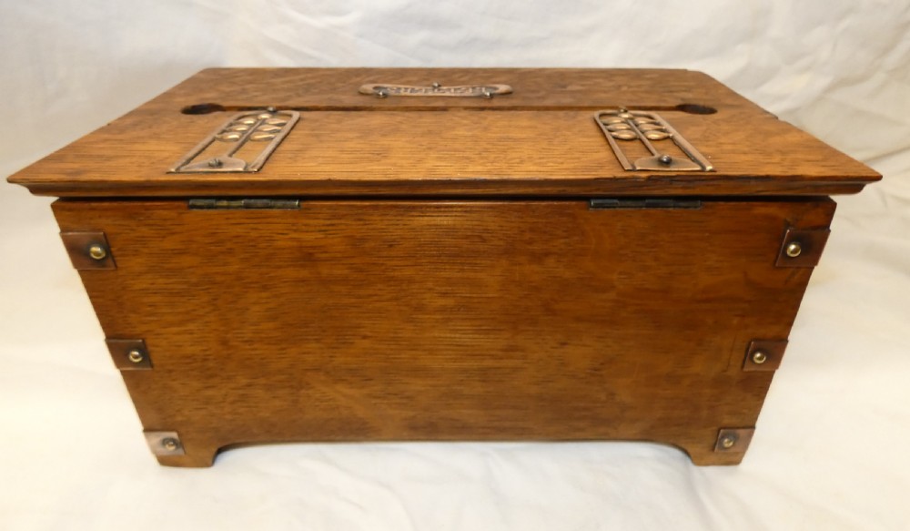 An antique Arts and Crafts solid oak letter box featuring decorative copper strap hinges, corner brackets, a top letter slot, and a central embossed copper plaque reading LETTERS. View VIII