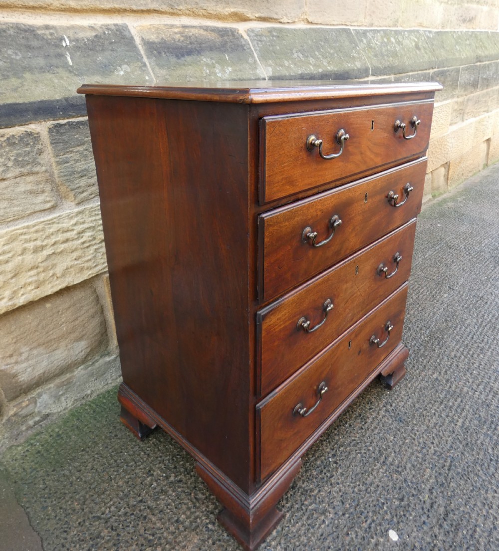 A small Georgian mahogany chest featuring four graduated drawers with brass swan-neck handles and bracket feet. View II