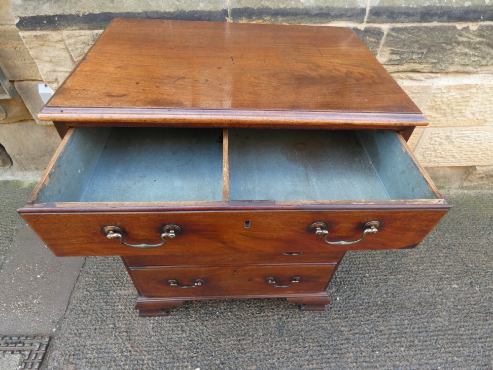 A small Georgian mahogany chest featuring four graduated drawers with brass swan-neck handles and bracket feet. View VIII