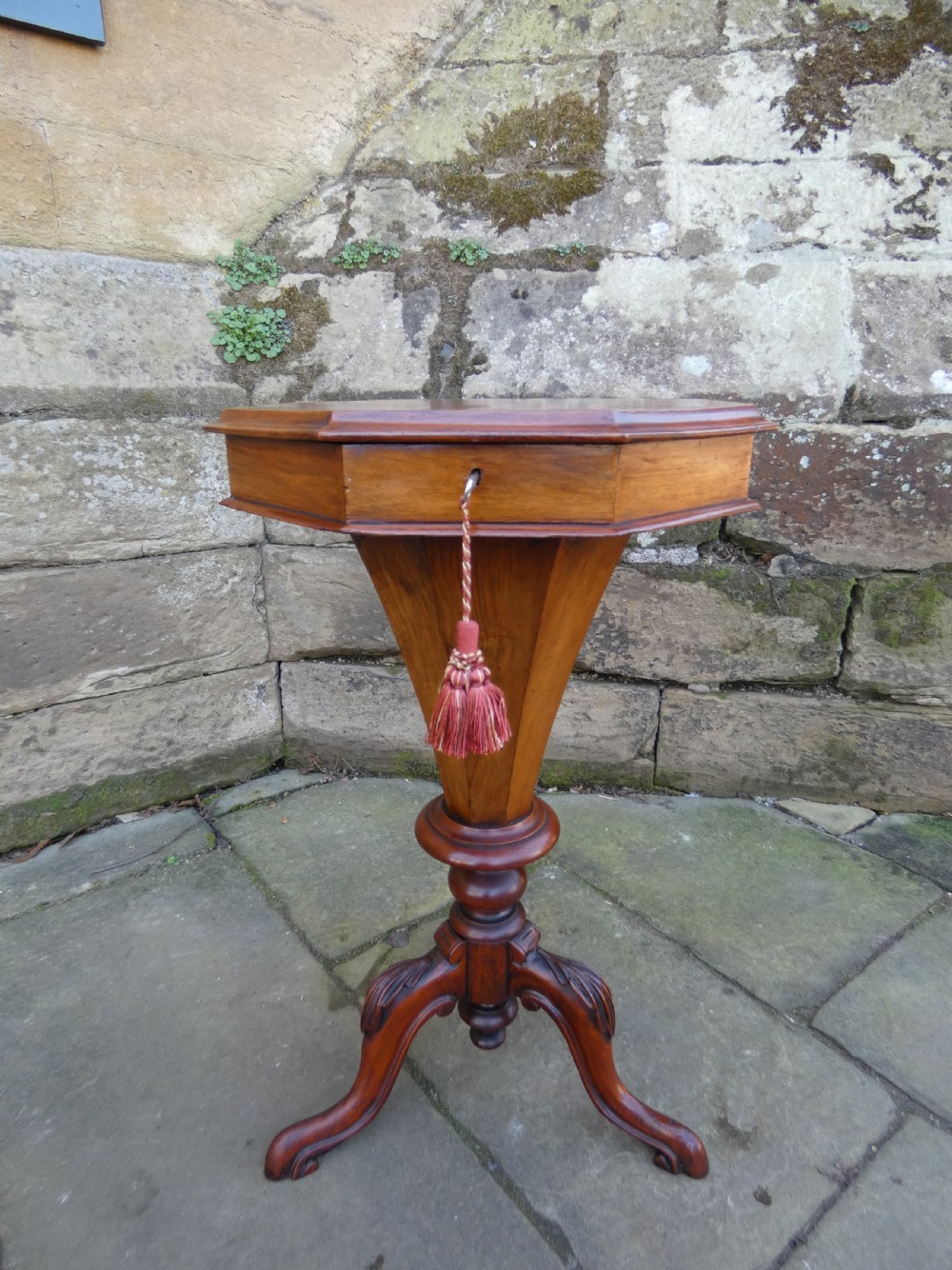 An octagonal Victorian rosewood sewing table featuring floral marquetry inlay on the top, a tapered trumpet base, and carved tripod feet. View III