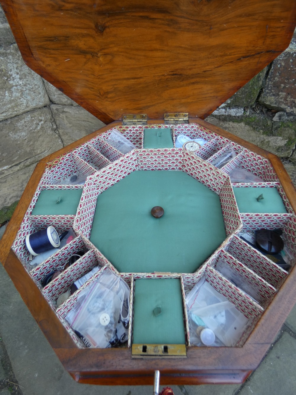 An octagonal Victorian rosewood sewing table featuring floral marquetry inlay on the top, a tapered trumpet base, and carved tripod feet. View VI