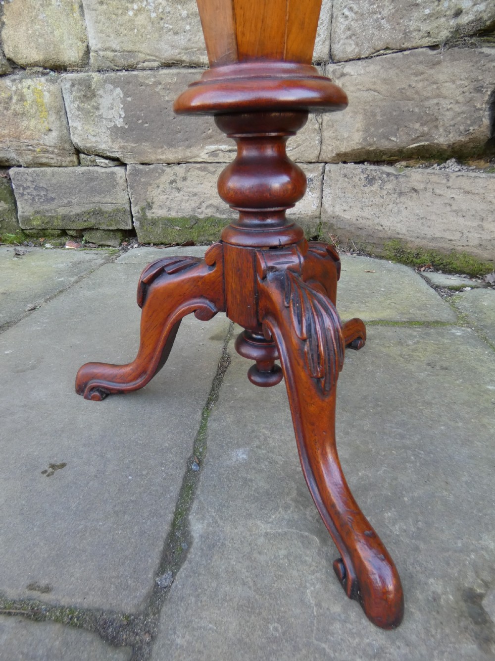 An octagonal Victorian rosewood sewing table featuring floral marquetry inlay on the top, a tapered trumpet base, and carved tripod feet. View VIII