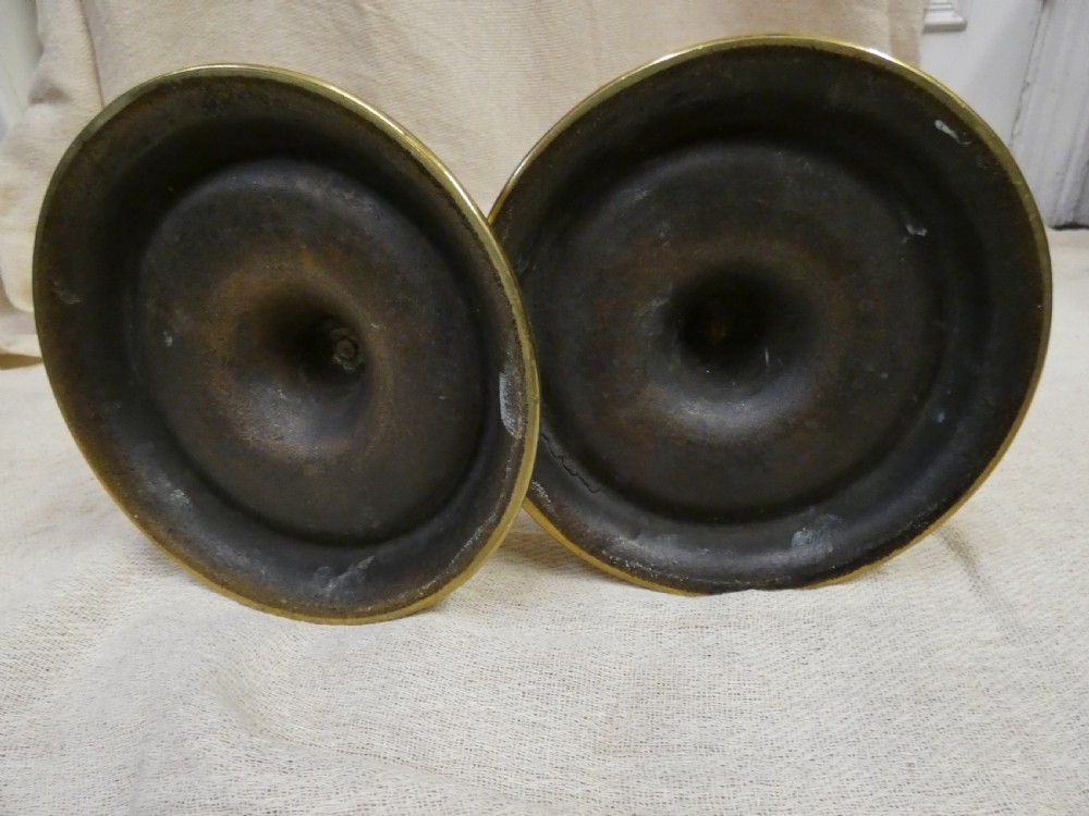 A pair of tall brass candlesticks featuring open barley twist stems and circular moulded bases. View IV