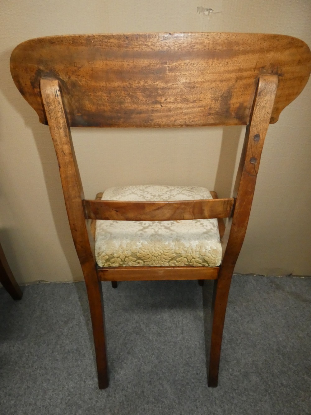 A set of eight antique mahogany dining chairs featuring curved bar backs, turned front legs, and mustard patterned fabric seats. View VII