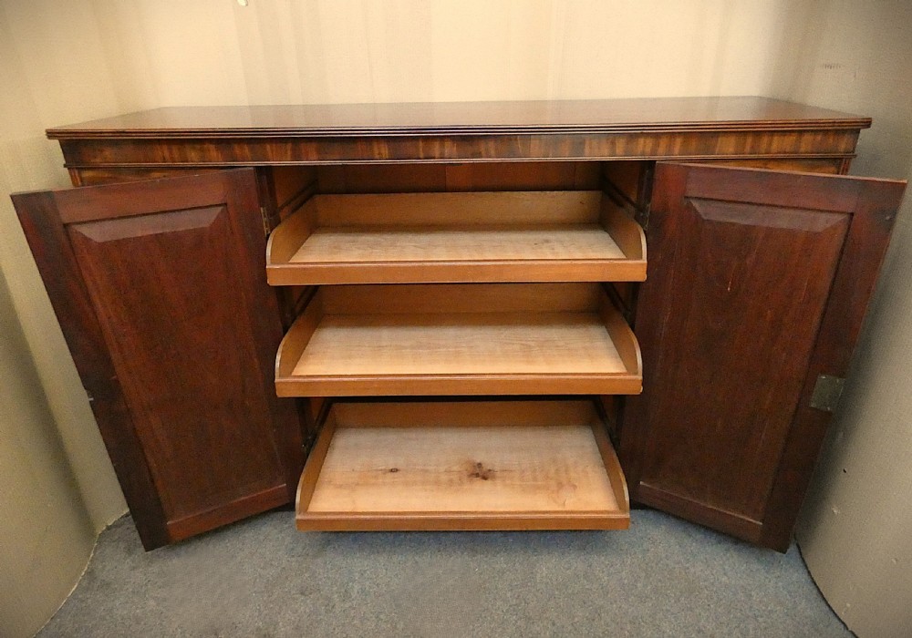 A Georgian mahogany low linen press featuring two central panelled doors flanked by eight side drawers with turned wooden knobs. View III
