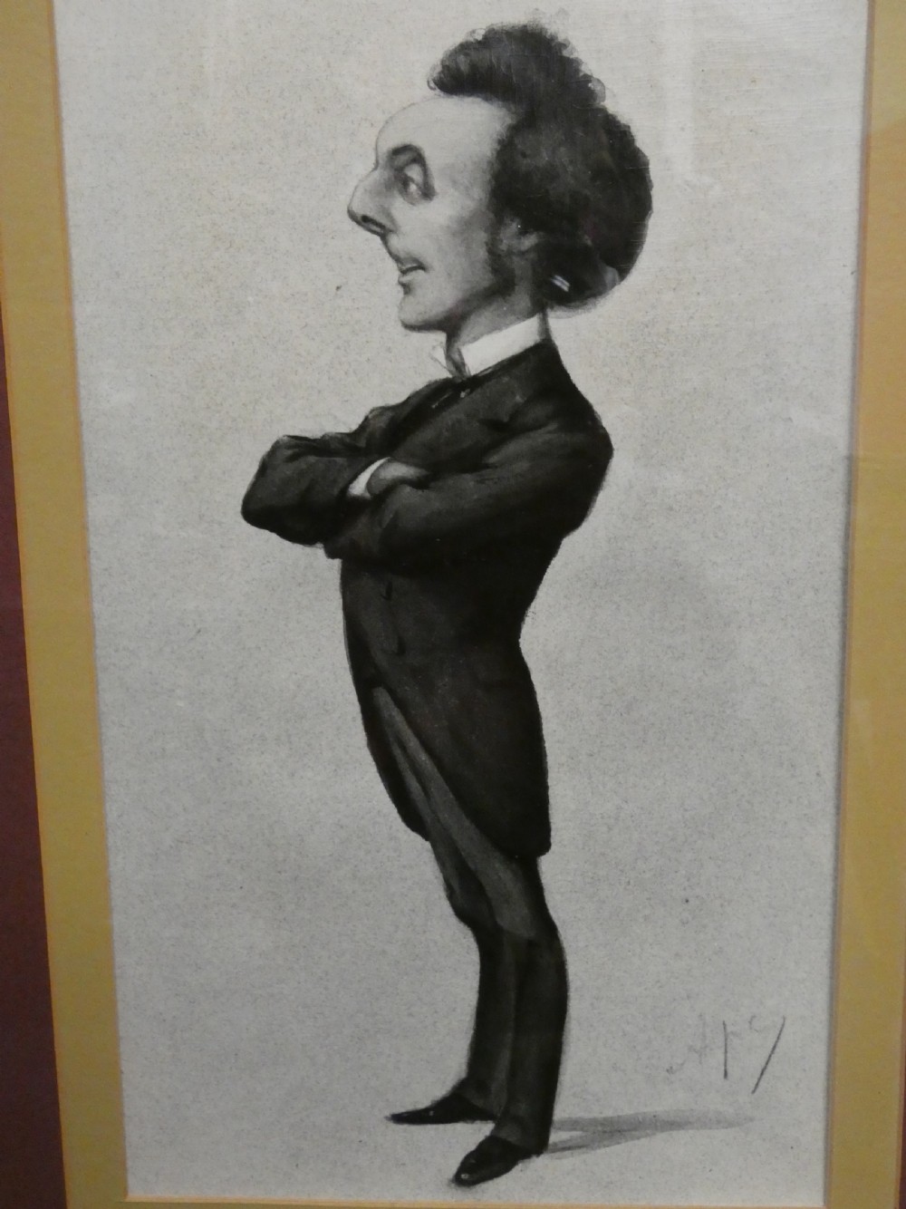 A set of six dark wooden frames, each housing two framed Victorian Vanity Fair caricature lithographs of gentlemen set against cream backgrounds with burgundy mounts. View III