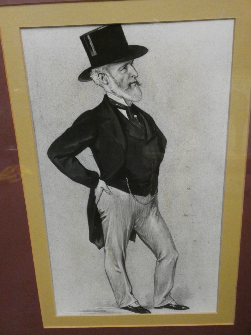 A set of six dark wooden frames, each housing two framed Victorian Vanity Fair caricature lithographs of gentlemen set against cream backgrounds with burgundy mounts. View VIII