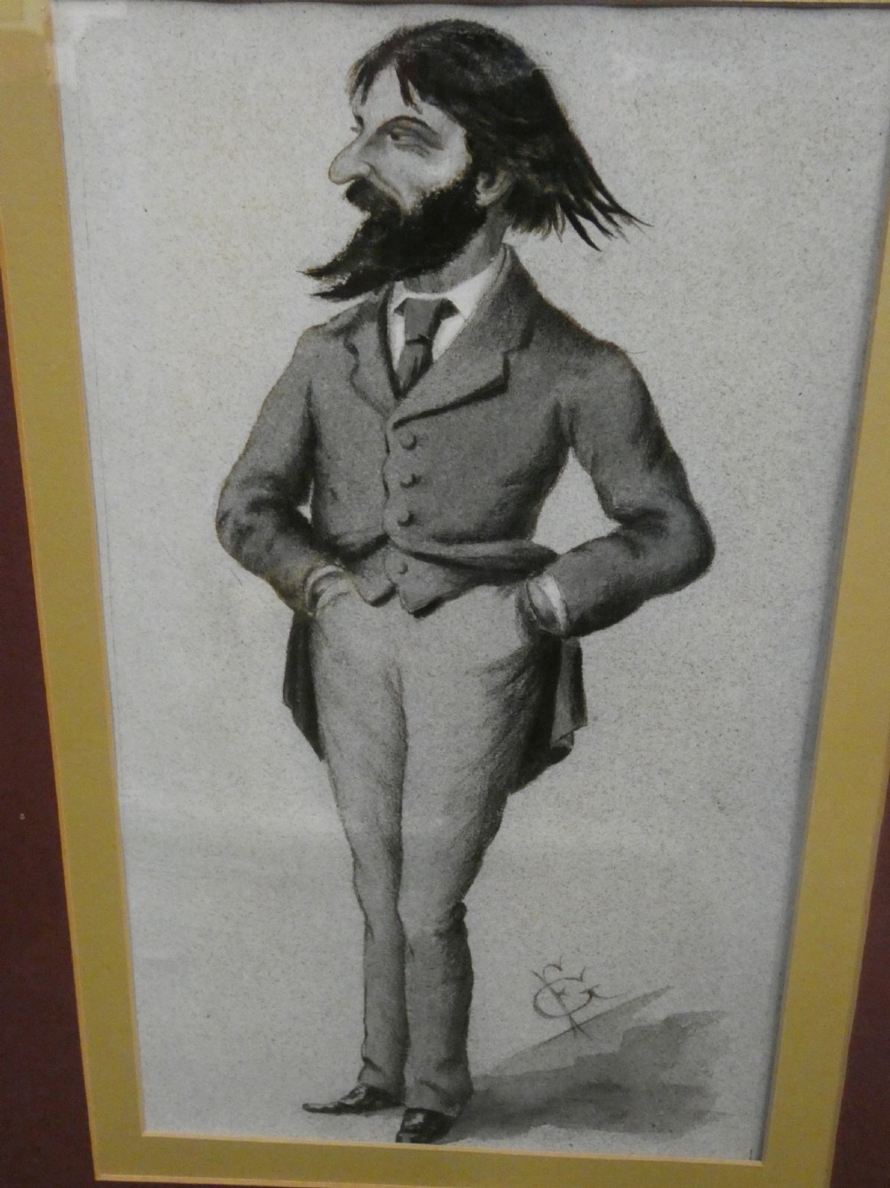 A set of six dark wooden frames, each housing two framed Victorian Vanity Fair caricature lithographs of gentlemen set against cream backgrounds with burgundy mounts. View IX