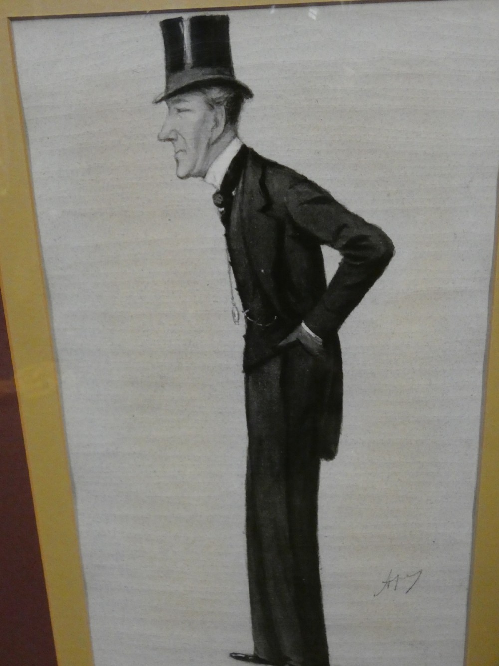 A set of six dark wooden frames, each housing two framed Victorian Vanity Fair caricature lithographs of gentlemen set against cream backgrounds with burgundy mounts. View XII