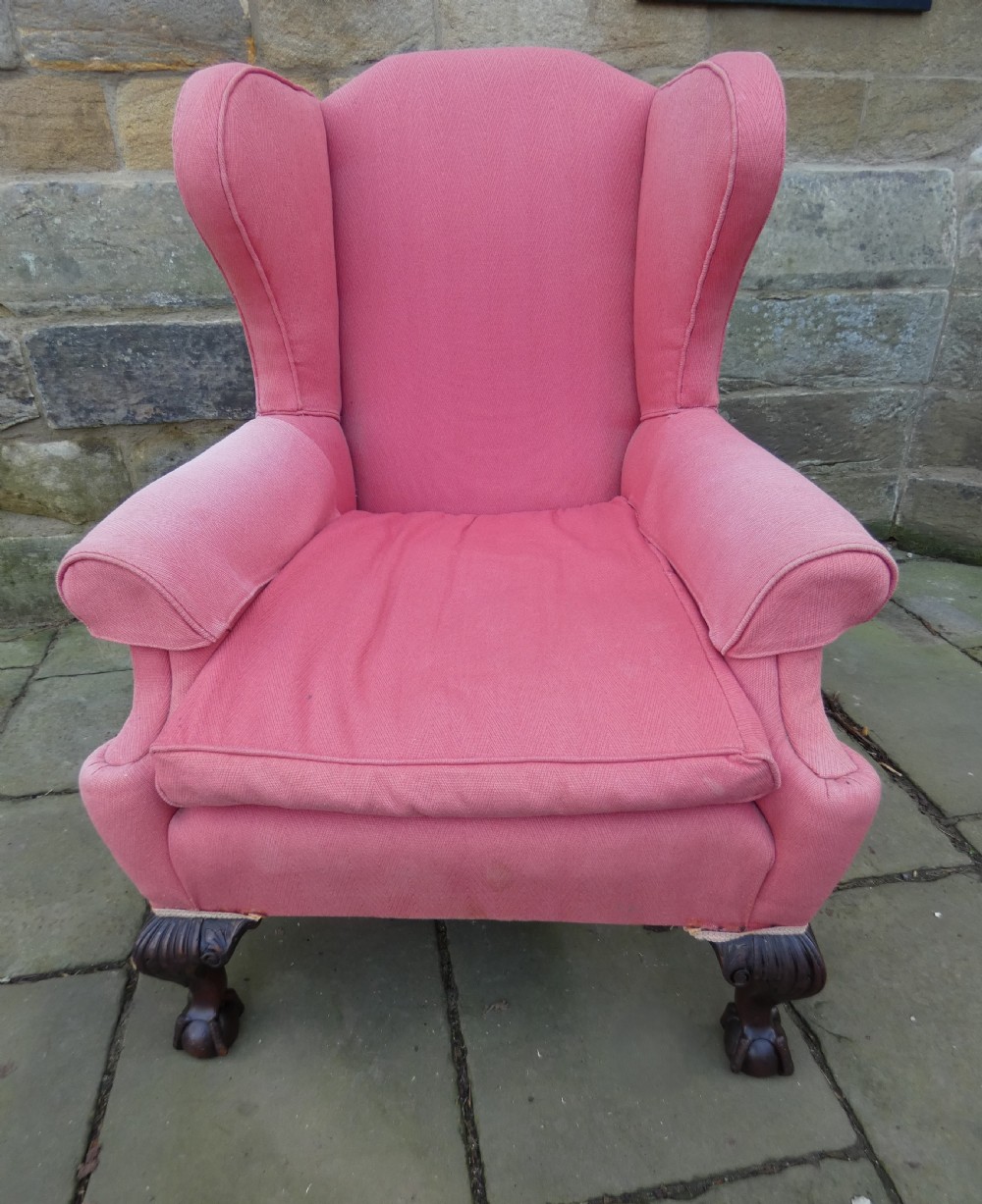 A 19th-century wingback armchair upholstered in rose pink fabric with carved mahogany cabriole front legs resting on ball-and-claw feet. View II