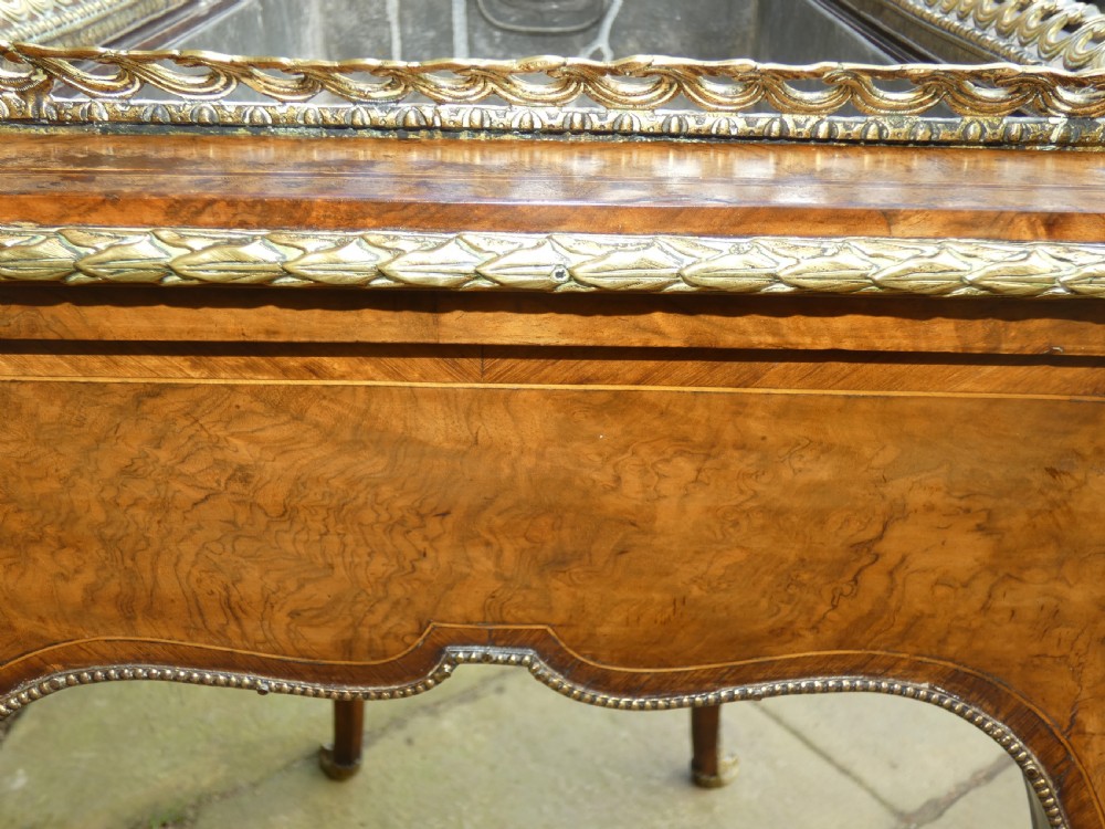 A French Louis XV style burr walnut jardiniere table with cabriole legs, ormolu mounts, a central porcelain plaque, and a brass gallery rim. View VII