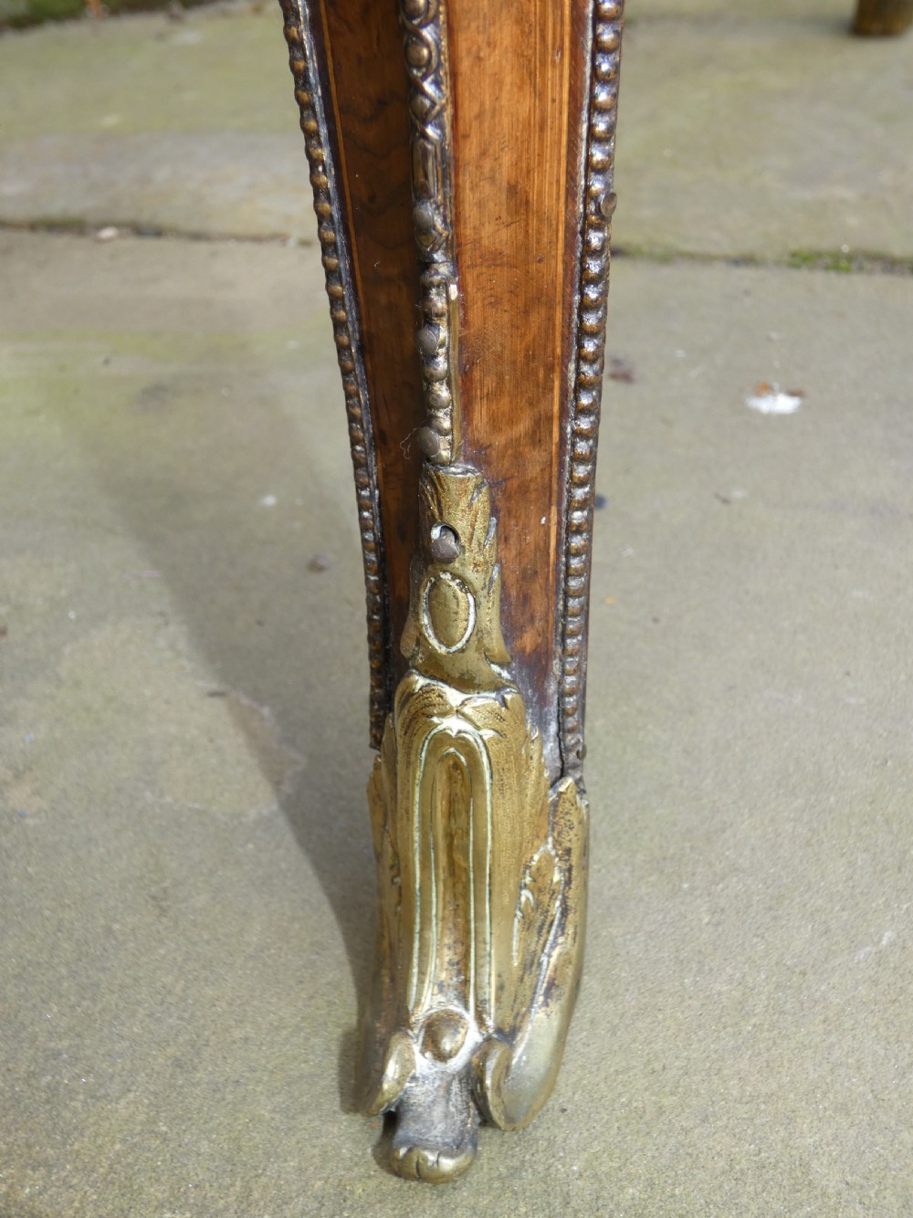 A French Louis XV style burr walnut jardiniere table with cabriole legs, ormolu mounts, a central porcelain plaque, and a brass gallery rim. View VIII