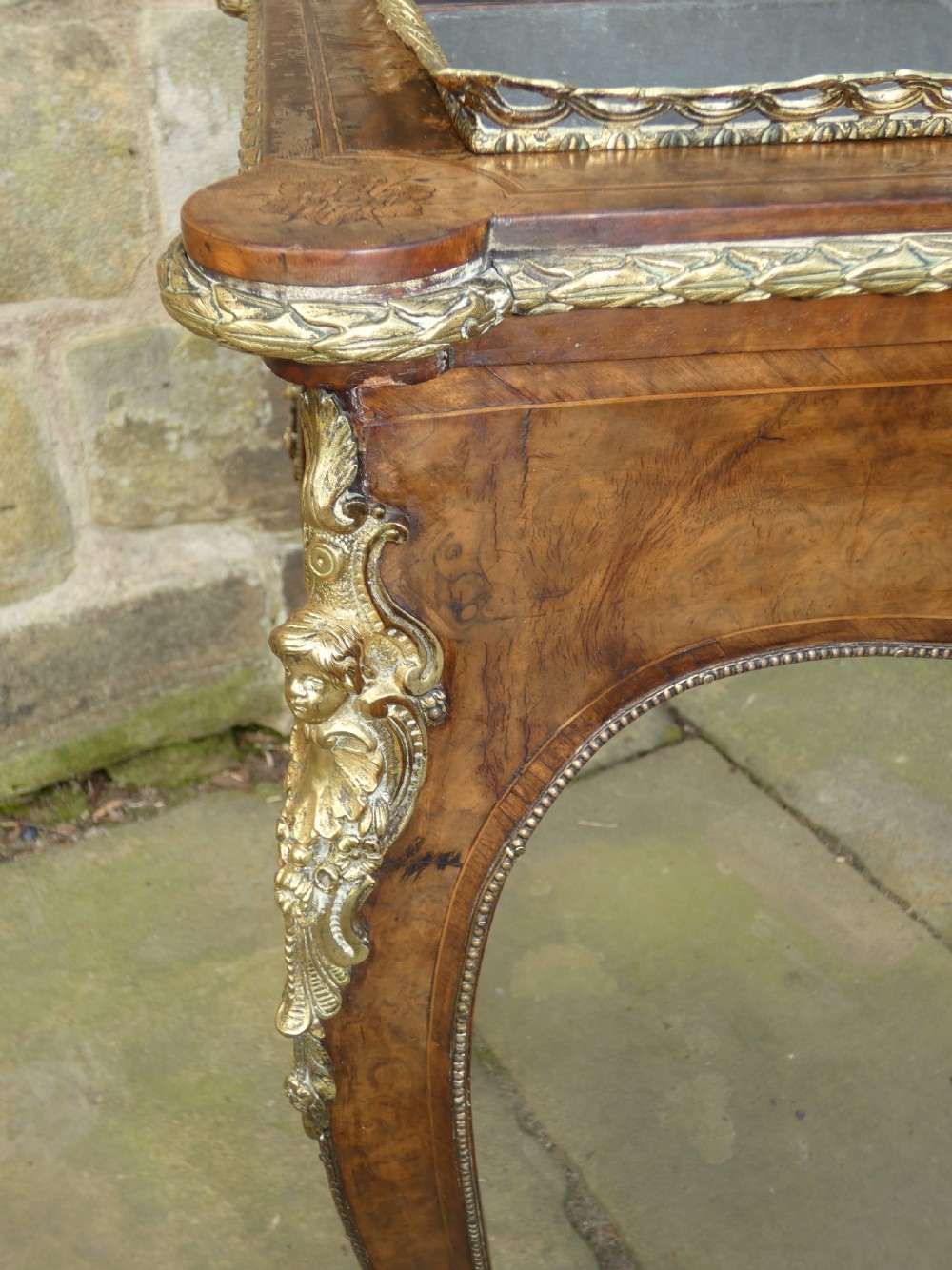 A French Louis XV style burr walnut jardiniere table with cabriole legs, ormolu mounts, a central porcelain plaque, and a brass gallery rim. View XI