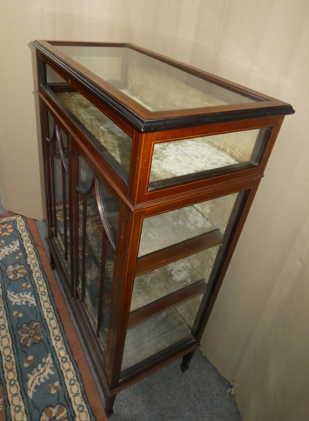 An inlaid mahogany bijouterie cabinet featuring a glass display section at the top, two glazed doors with astragal bars below, and tapered legs. View III