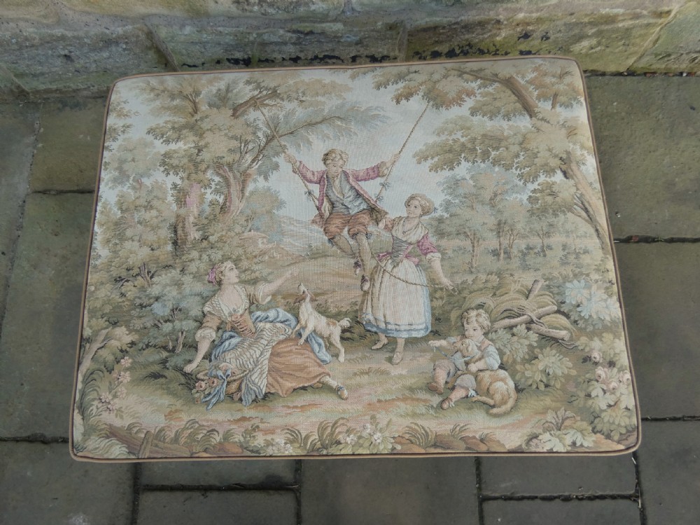 A large square upholstered centre stool featuring a tapestry top with figures in a landscape and dark carved mahogany cabriole legs with ball and claw feet. View III