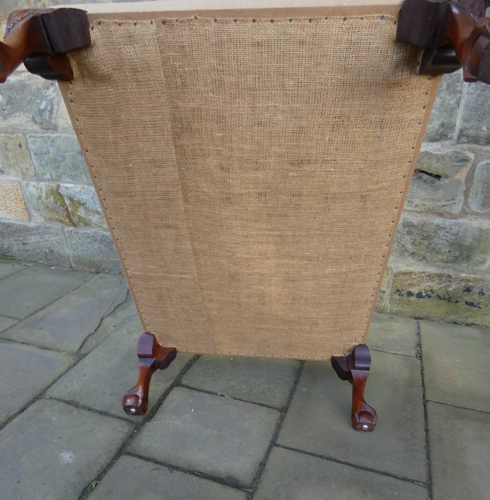 A large square upholstered centre stool featuring a tapestry top with figures in a landscape and dark carved mahogany cabriole legs with ball and claw feet. View VIII