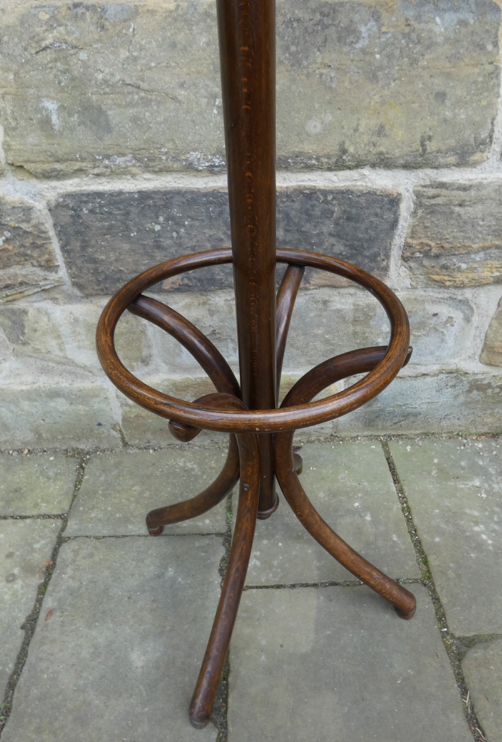 A dark brown steam-bent beechwood coat stand featuring a revolving top with double scrolled hooks, an umbrella ring, and a four-legged splayed base. View IV