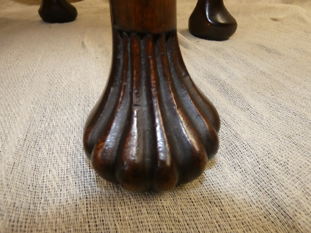 An oval upholstered antique dressing stool featuring cream damask fabric and dark mahogany cabriole legs with carved ball and claw feet. View IV
