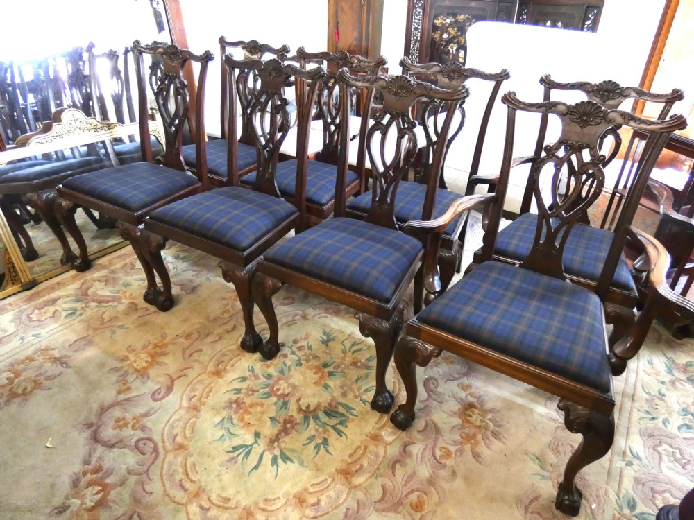 A set of eight dark mahogany Chippendale style dining chairs featuring carved pierced splats, cabriole legs with ball and claw feet, and blue tartan upholstered seats. View IV