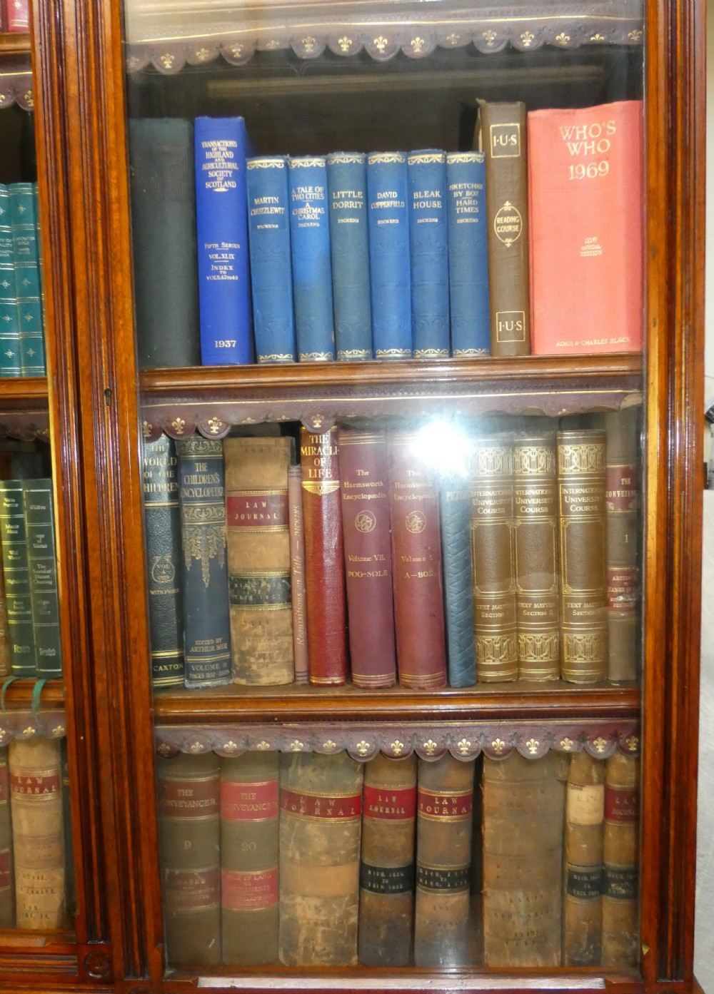 A large three-section antique oak bookcase featuring glazed upper doors above panelled lower cupboards. View IX
