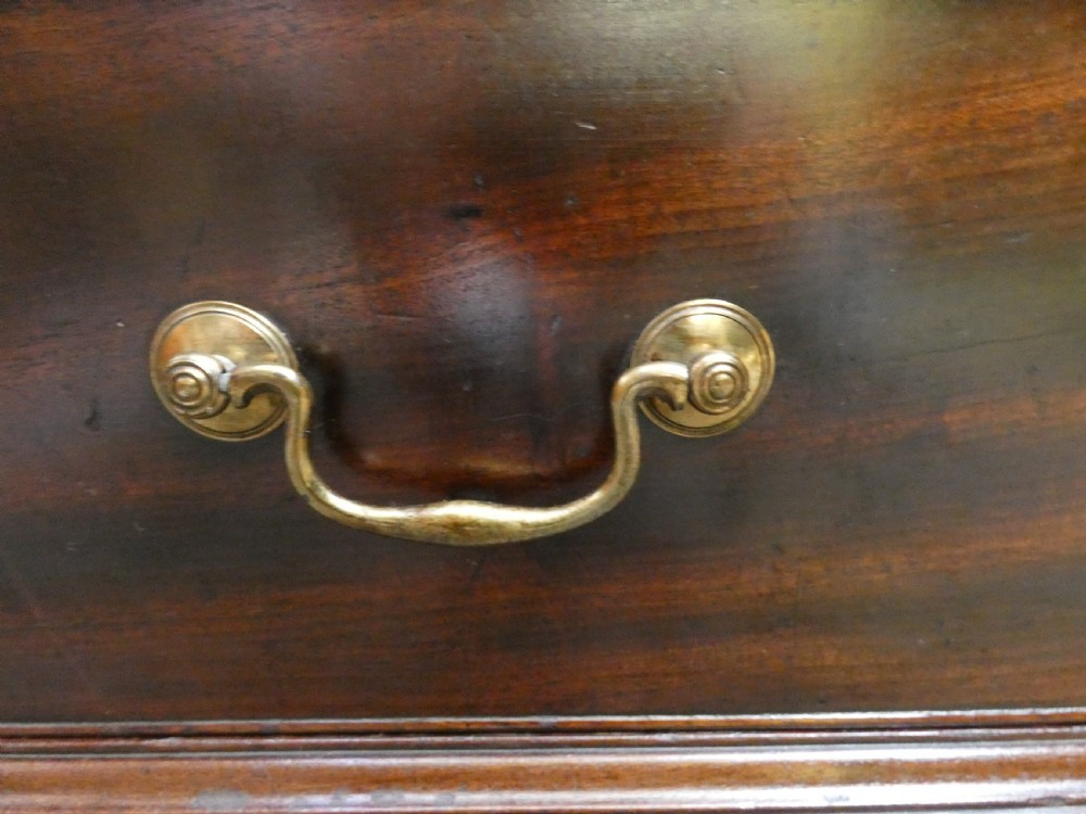 A Georgian mahogany dwarf press cupboard featuring twin panelled doors over a single drawer with brass handles. View VI