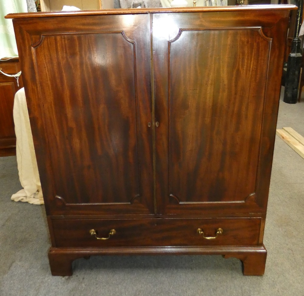 A Georgian mahogany dwarf press cupboard featuring twin panelled doors over a single drawer with brass handles. View VIII