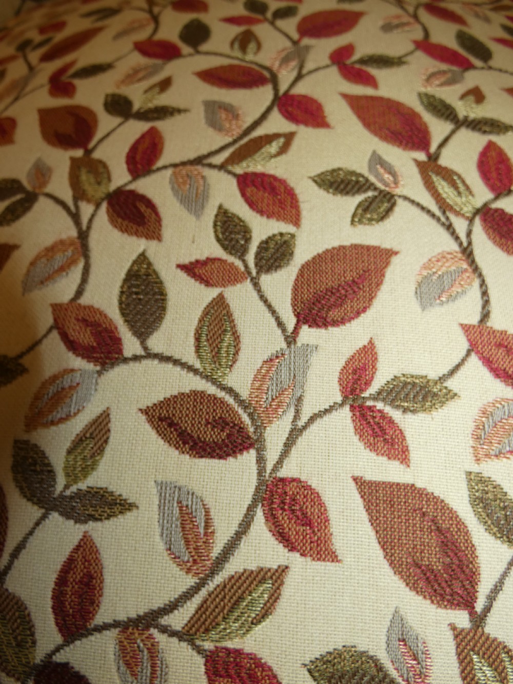 A Victorian low-seated button-back nursing chair featuring a leaf-patterned upholstery fabric and dark turned timber front legs with castors. View VII