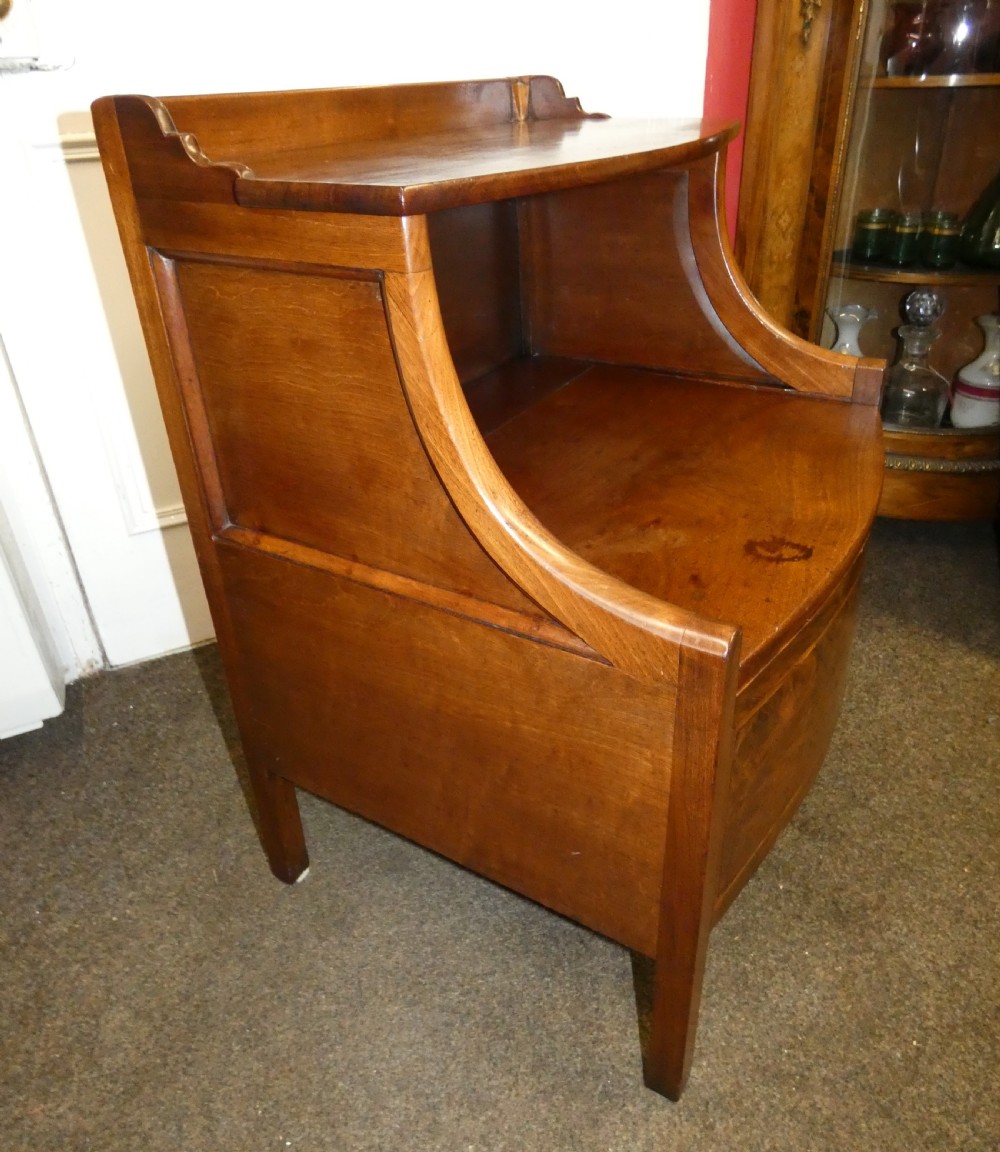 An antique Georgian mahogany bedside commode featuring an open upper shelf section with curved sides and a veneered lower cabinet. View IV