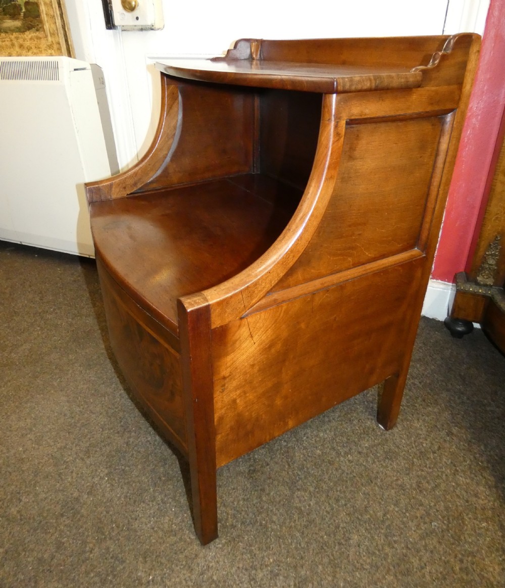 An antique Georgian mahogany bedside commode featuring an open upper shelf section with curved sides and a veneered lower cabinet. View VI